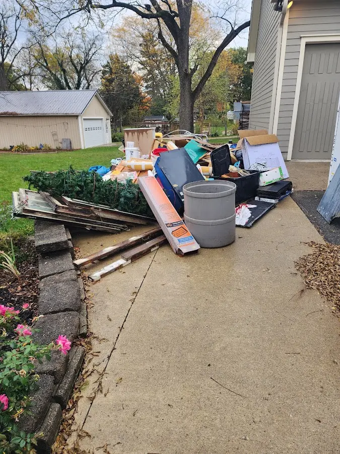Dumpster being loaded with debris for Estate Cleanout Dumpster Rental in Bellingham
